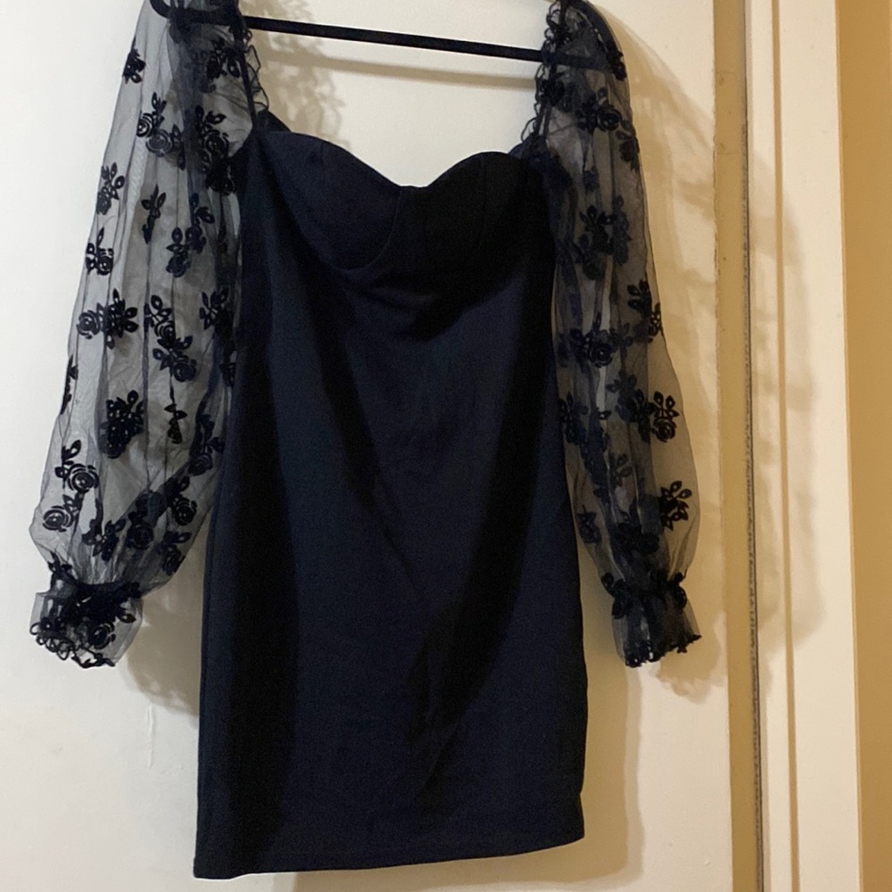 black mini heart shaped neckline with puffed sleeves. never worn